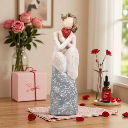 A girl sitting and holding a heart Valentine’s Day gift